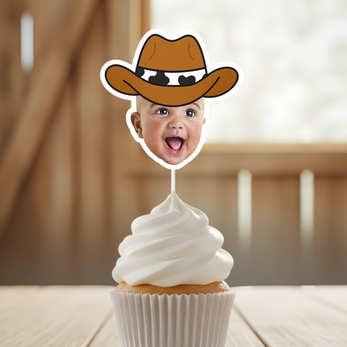 Close up of personalized cowboy baby face cupcake topper featuring smiling infant wearing brown cowboy hat, displayed on vanilla cupcake with white buttercream frosting. Ideal for cowboy first birthday parties, wild west baby celebrations, rodeo themed smash cake photos, and country western dessert table décor. Custom baby photo cupcake pick designed to highlight the child’s face.