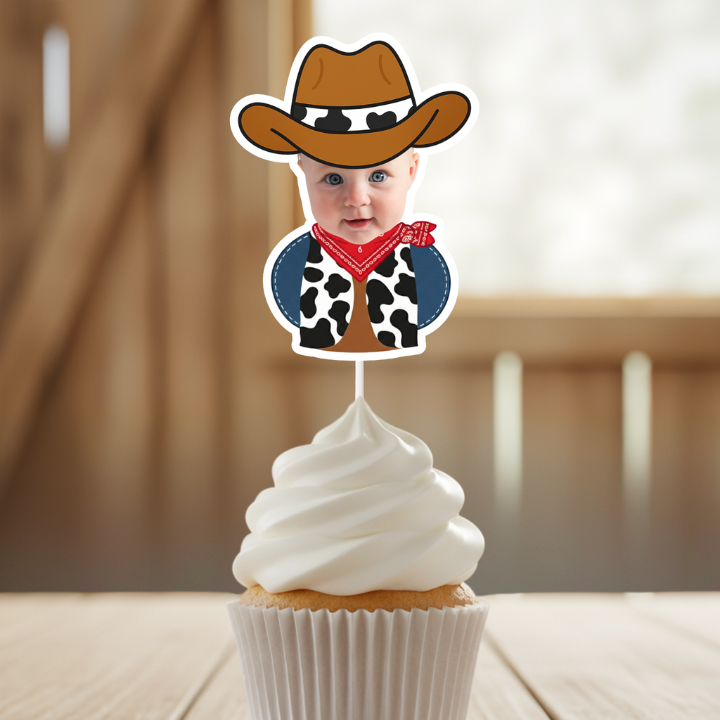 Close up of personalized cowboy baby photo cupcake topper featuring infant wearing brown cowboy hat, red bandana, and cow print vest mounted on buttercream cupcake. Perfect for cowboy first birthday parties, wild west baby celebrations, rodeo themed smash cake décor, and western milestone events. Custom photo cupcake pick designed to highlight the child’s face for country themed birthday parties and barnyard dessert tables.