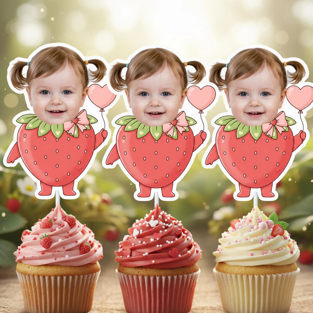 Three strawberry-themed cupcake toppers with a blurred background