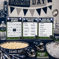 A football-themed party decoration and game kit setup on a dark table, including a football bingo board, watch party trivia sheet, game day predictions card, popcorn bowl, helmets, cups, napkins, and a water bottle.