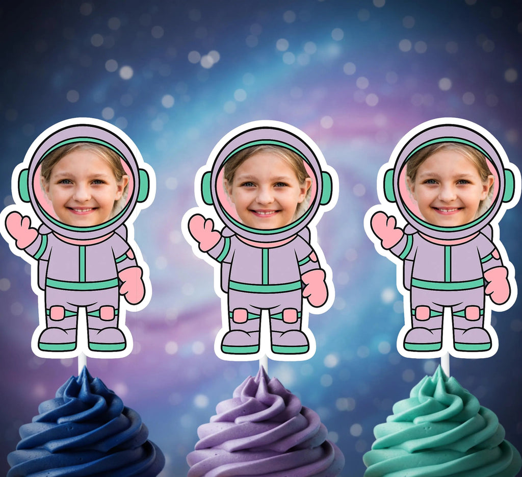 Three cupcakes with colorful frosting topped with astronaut-themed cupcake toppers against a starry space background.