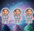 Three cupcakes with colorful frosting topped with astronaut-themed cupcake toppers against a starry space background.