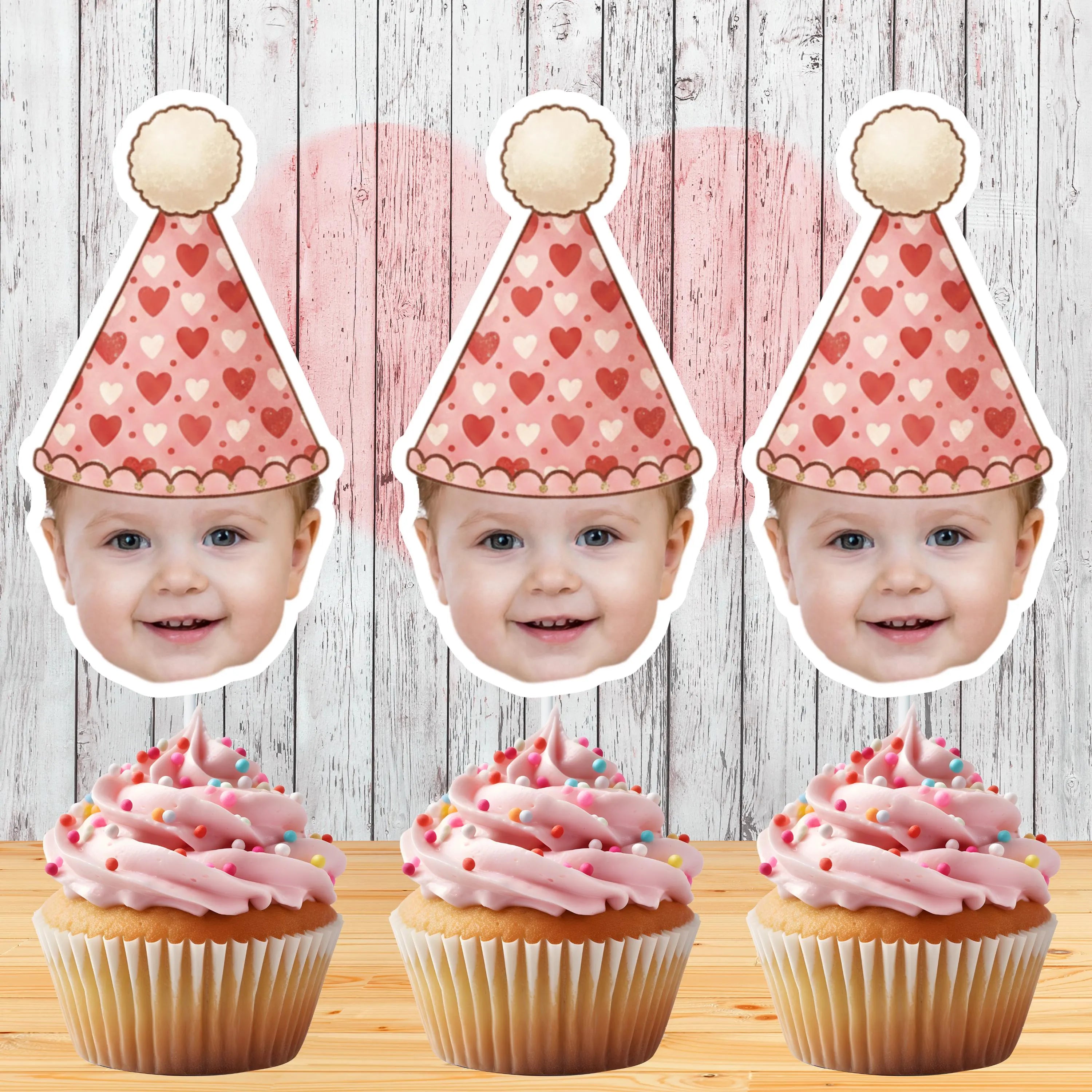 Three identical images of a child with a heart-patterned party hat, surrounded by pink cupcakes with sprinkles on a wooden surface.