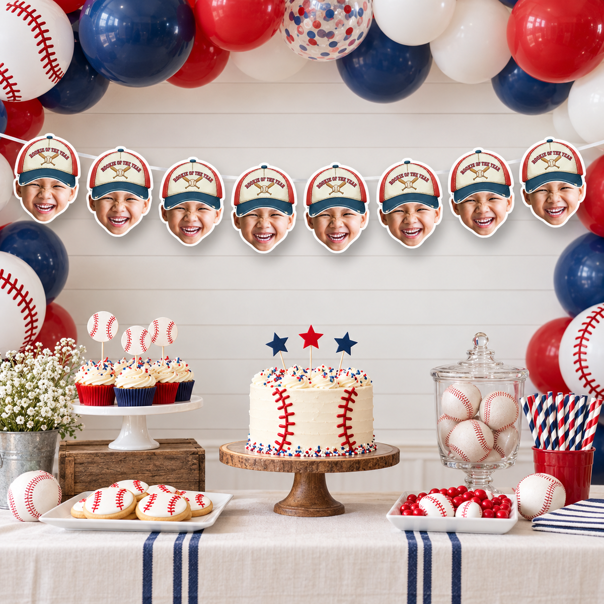 Personalized vintage Rookie of the Year baseball face banner displayed indoors with baseballs wooden crates and classic red white and navy party decorations