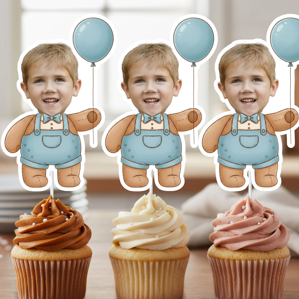 Three cupcakes with different colored frostings and a child's face cutout in overalls and balloons.
