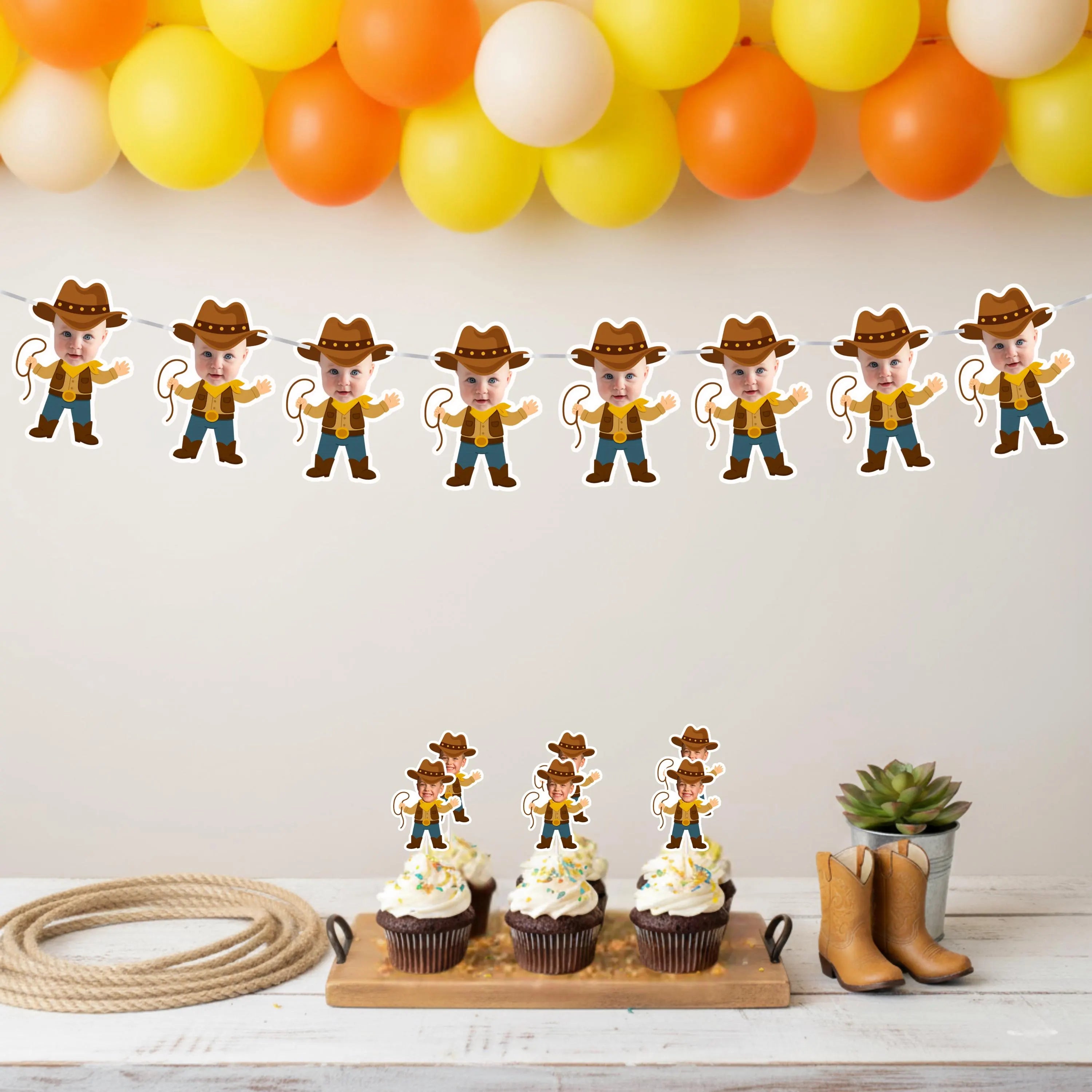 Cowboy-themed birthday party setup with cowboy photo banner, balloons, decorations, and cupcakes on a white wall.