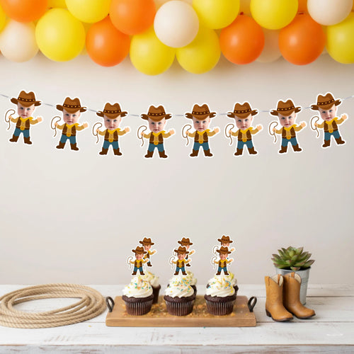 Cowboy-themed birthday party setup with cowboy photo banner, balloons, decorations, and cupcakes on a white wall.