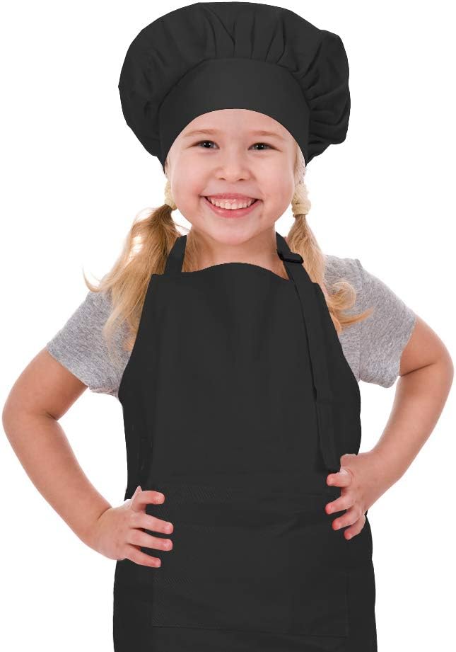 Child wearing a black chef hat and apron on a white background