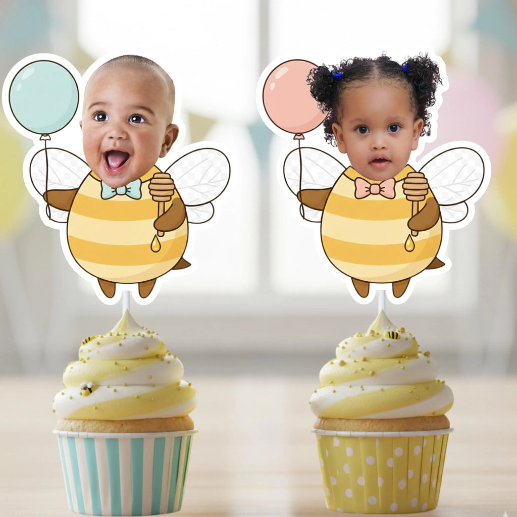 Two cupcakes with bee-themed toppers featuring children's faces on a blurred background.