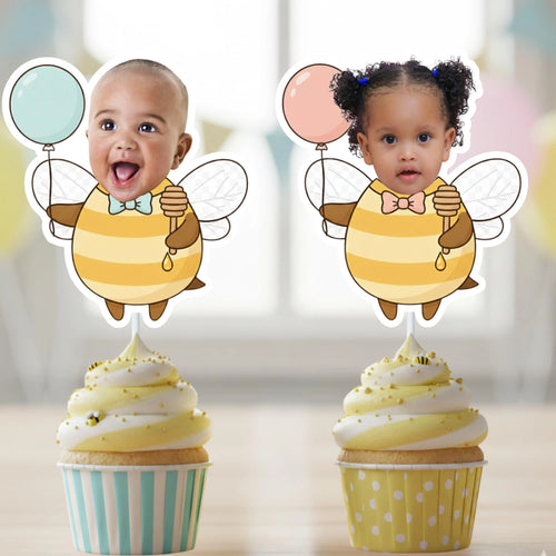 Boy and girl personalized bee photo cupcake toppers with blue and pink balloons, striped bee bodies, white wings, and honey dippers, displayed on cupcakes for a What Will It Bee gender reveal.