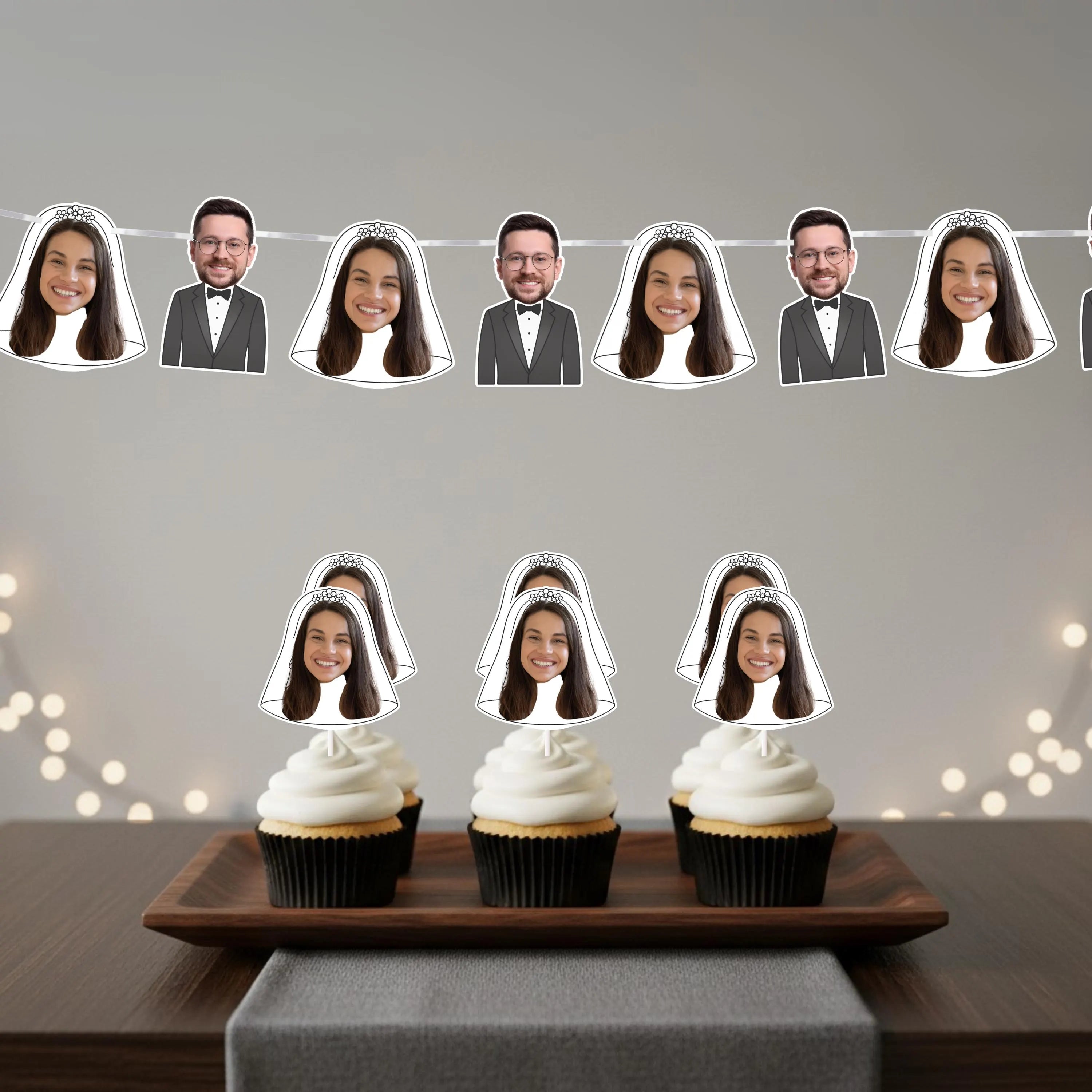 Cupcakes with face cutouts on a wooden tray against a gray background