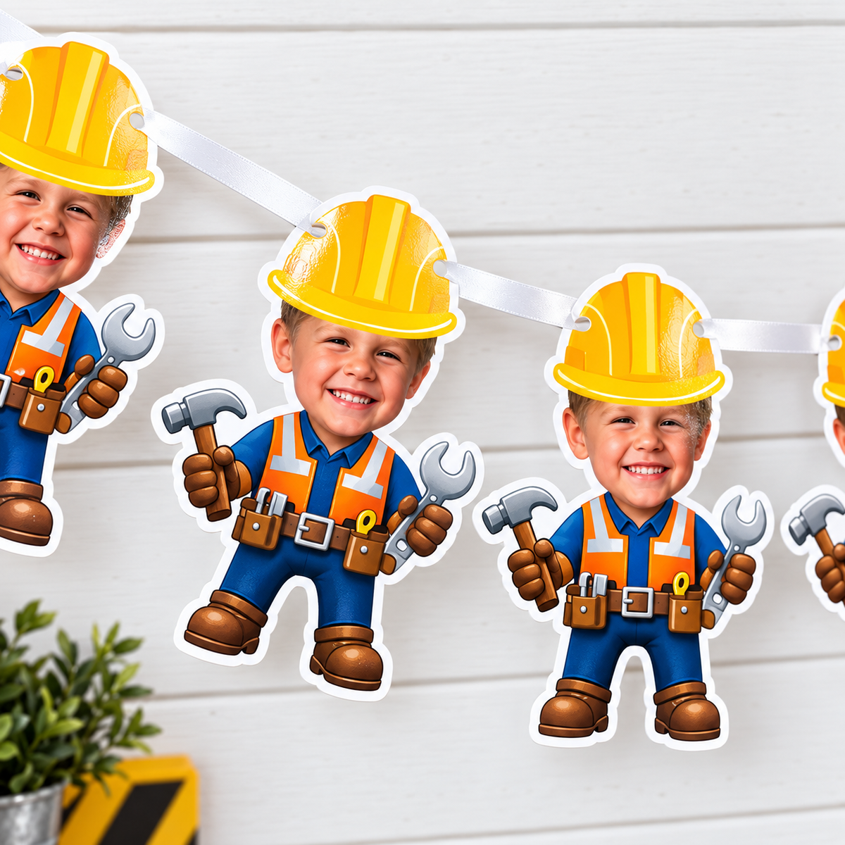 Close up of personalized construction birthday banner panels showing the child photo builder design laminated cardstock finish and white satin ribbon stringing