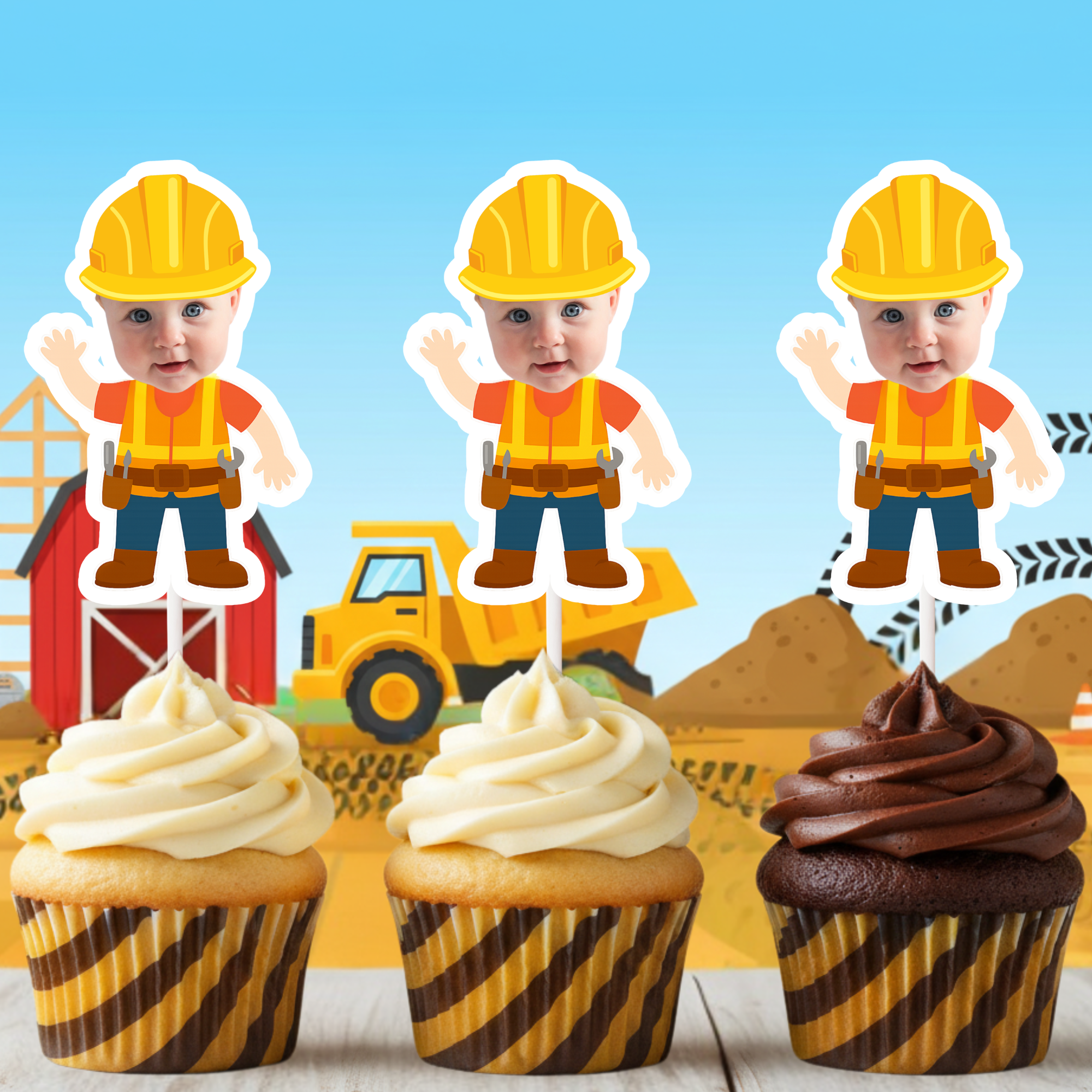 Three cupcakes with construction-themed toppers against a boy's construction birthday party table with a toy truck and building.
