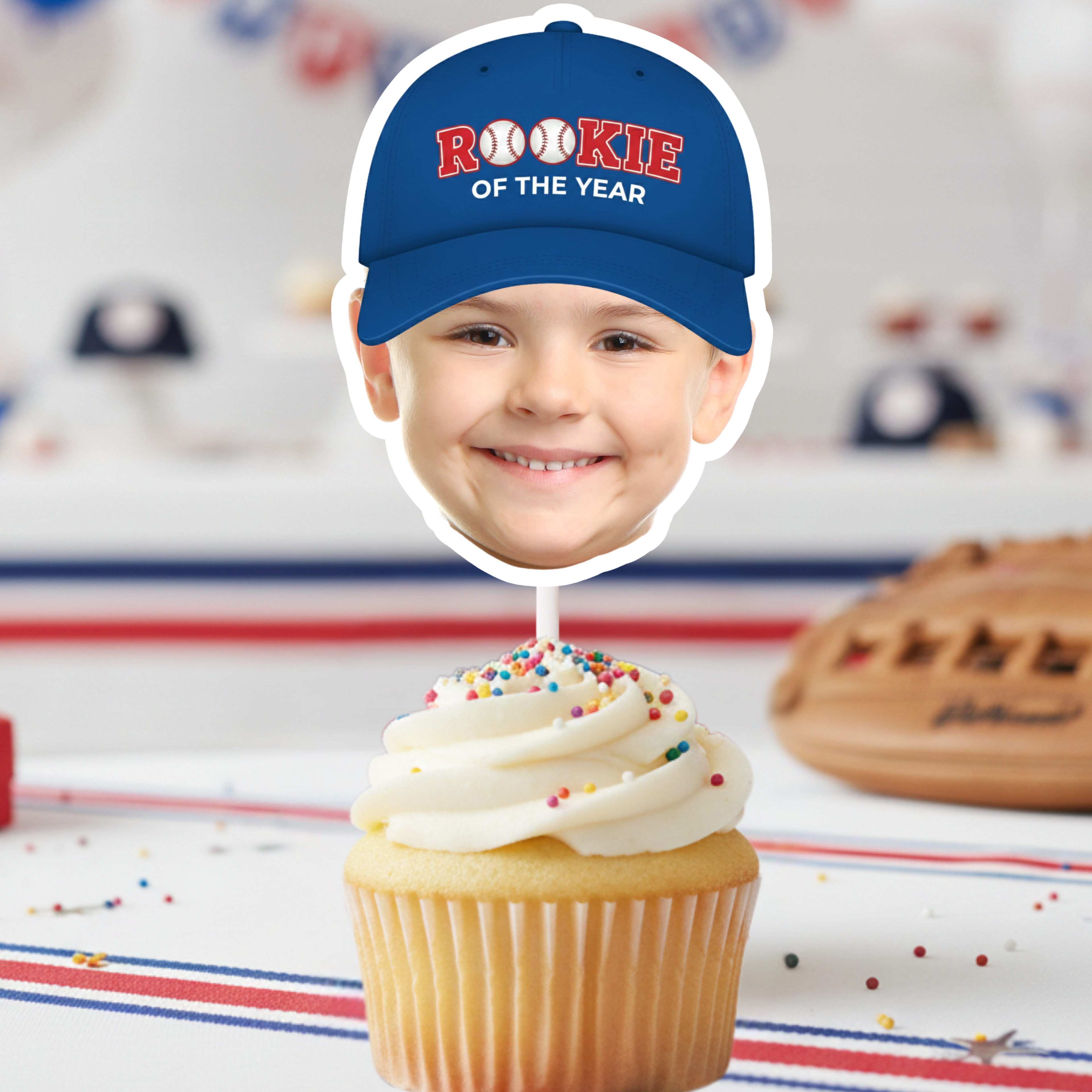Custom Rookie of the Year baseball birthday photo cupcake topper featuring a child’s face with blue cap design on frosted cupcake, styled with baseball glove and ball for an All Star sports themed birthday party.
