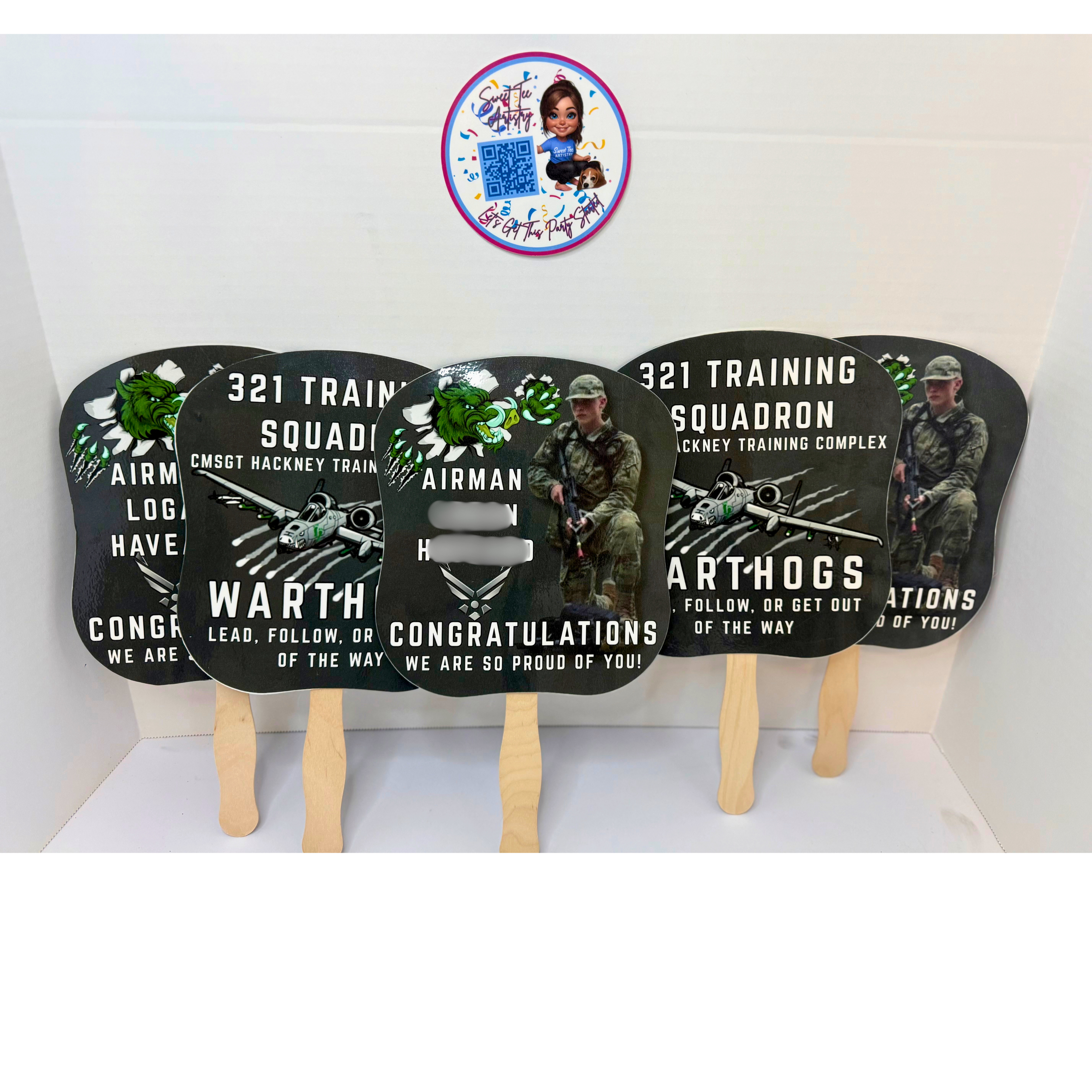 Personalized Air Force graduation fans featuring custom airman photos for 321 Training Squadron graduation ceremony celebration and military family keepsake decor. Four promotional fans with military-themed designs on sticks, featuring text and images of soldiers.