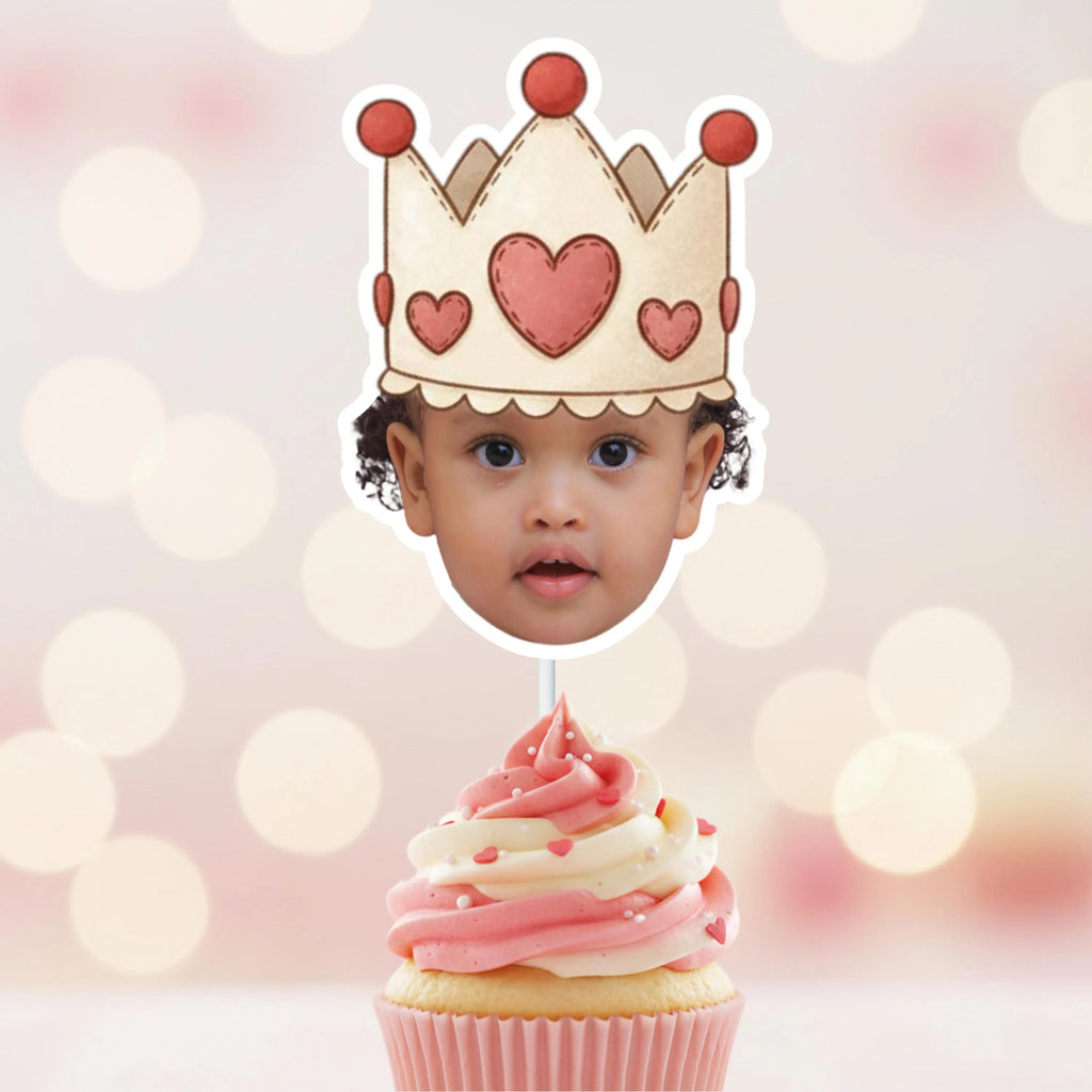 Custom princess face cupcake topper featuring a heart crown design displayed on a vanilla cupcake with soft pink frosting. Personalized royal birthday party decoration perfect for a Sweet One first birthday, little princess celebration, fairytale themed dessert table, or pink and gold royal party setup.