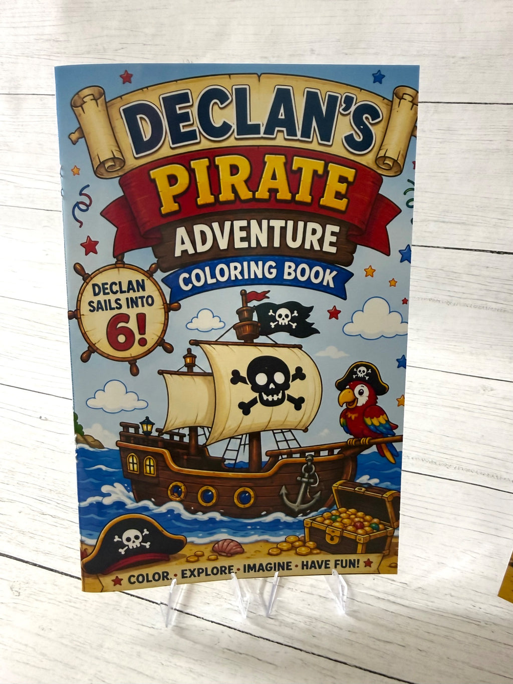 Personalized pirate birthday coloring book front cover with pirate ship, parrot, treasure chest, child name and age.