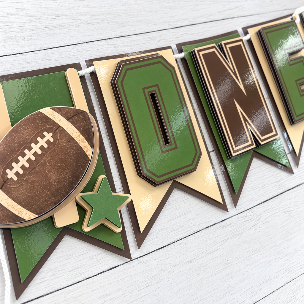 Closeup of layered cardstock ONE letters on a sage green brown and cream football highchair banner