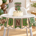 Layered cardstock First Year Down football highchair banner displayed with a first birthday cake