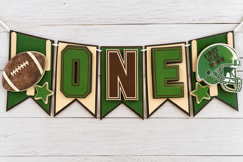 Full flat lay of First Year Down football highchair banner with five layered cardstock panels
