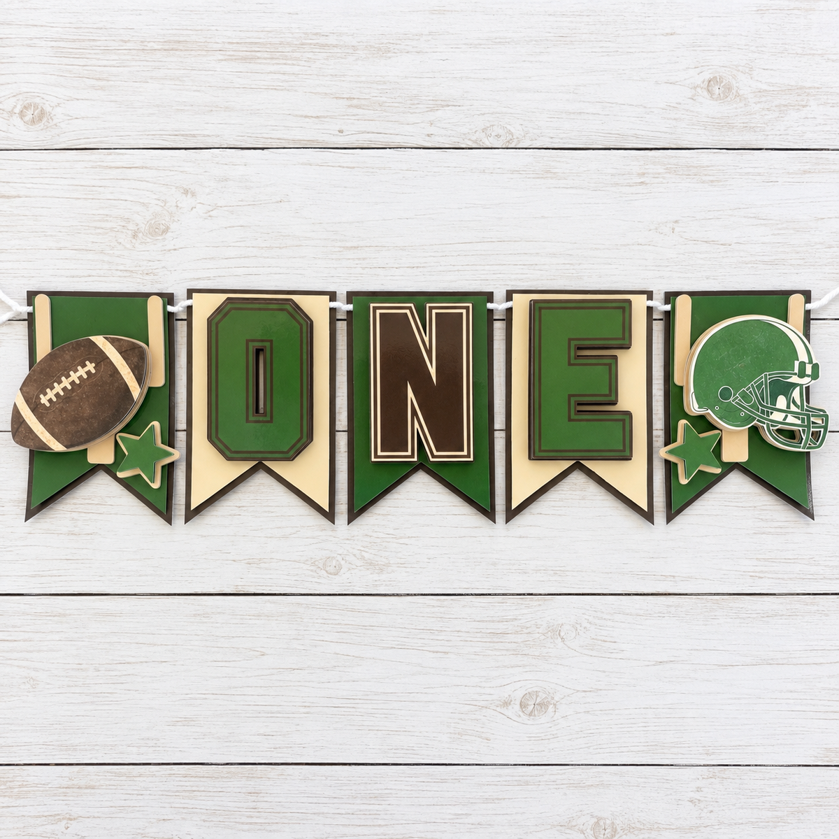Full First Year Down football highchair banner laid flat with football helmet stars and ONE panels