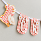 Close-up of the pink gingham number one and white goose end panel on the personalized One Silly Goose first birthday banner.