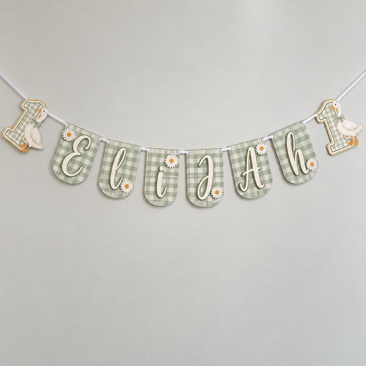 Personalized One Silly Goose first birthday banner in sage green gingham with the name Elijah, layered daisies, and goose number one end panels.