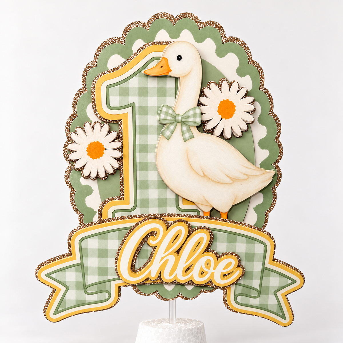 Personalized One Silly Goose birthday cake topper in sage green gingham with custom name and age, white goose, daisies and champagne gold glitter accents