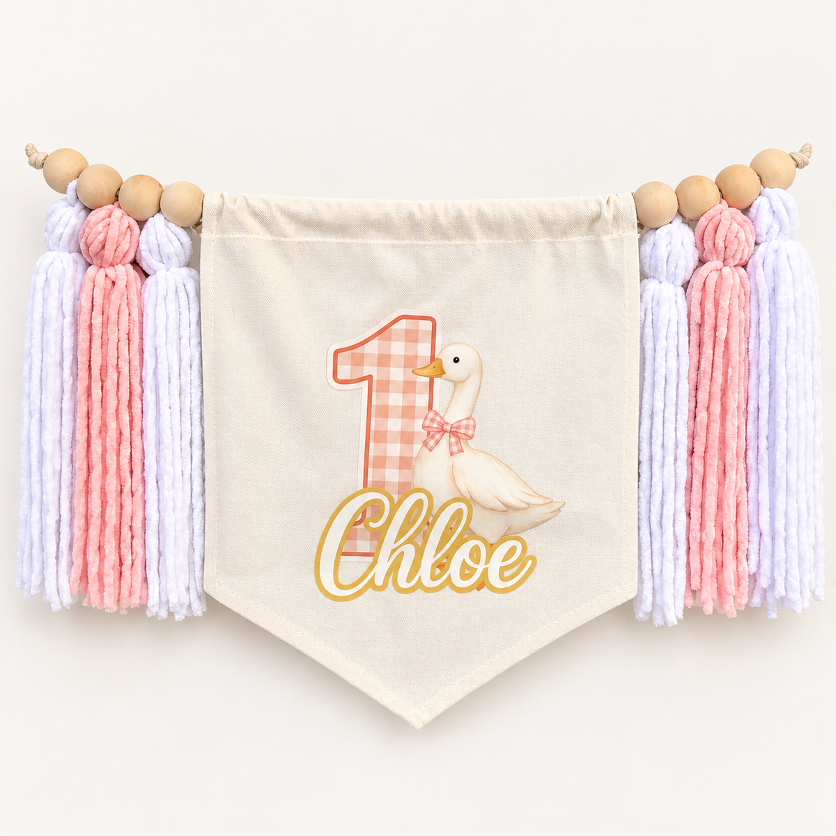 Pink One Silly Goose personalized first birthday high chair banner with custom name and age, cream canvas pennant, natural wooden beads, and pink and white yarn tassels.