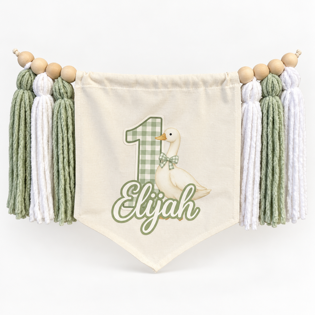 Sage green One Silly Goose personalized first birthday high chair banner with custom name and age, cream canvas pennant, natural wooden beads, and sage and white yarn tassels.