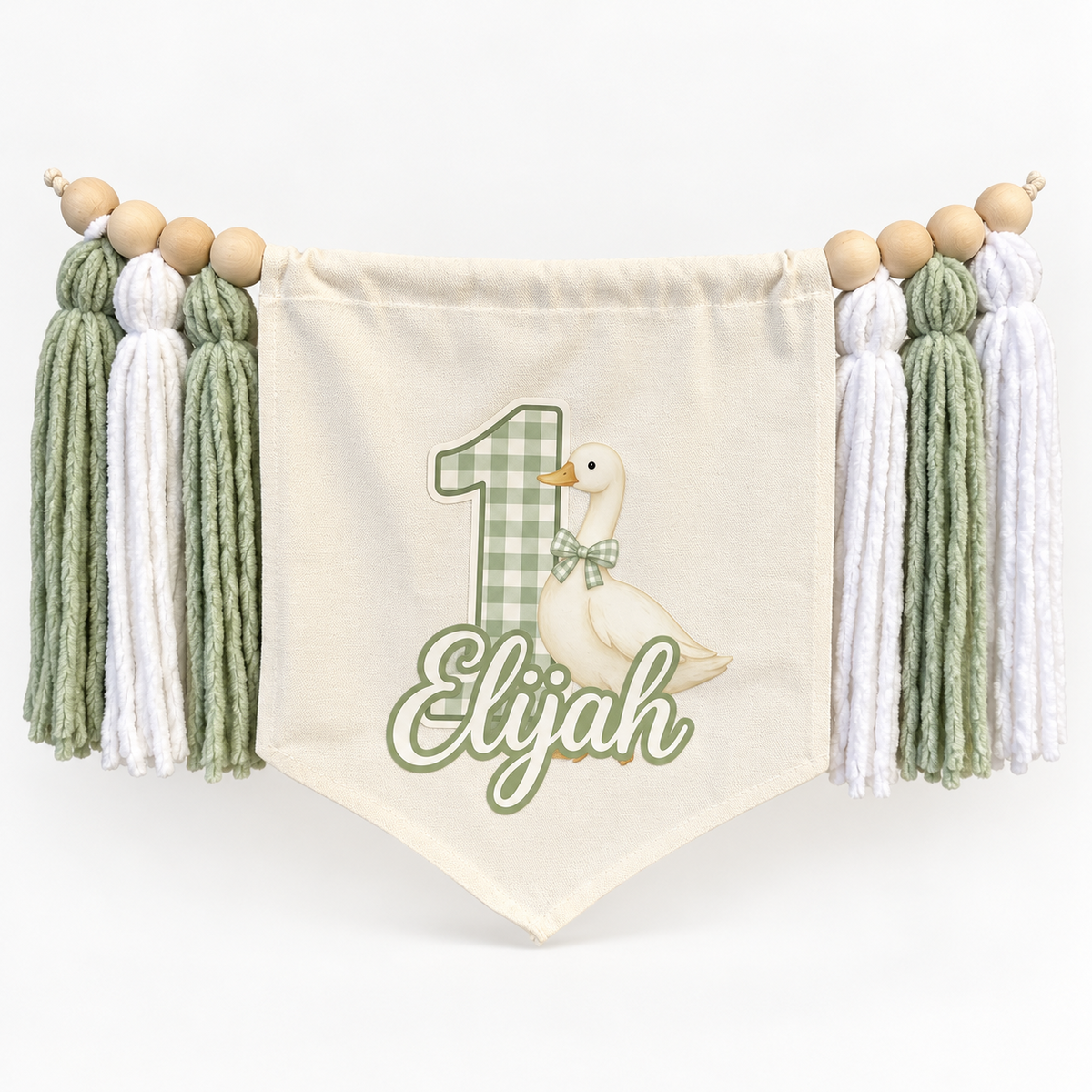 Sage green One Silly Goose personalized first birthday high chair banner with custom name and age, cream canvas pennant, natural wooden beads, and sage and white yarn tassels.