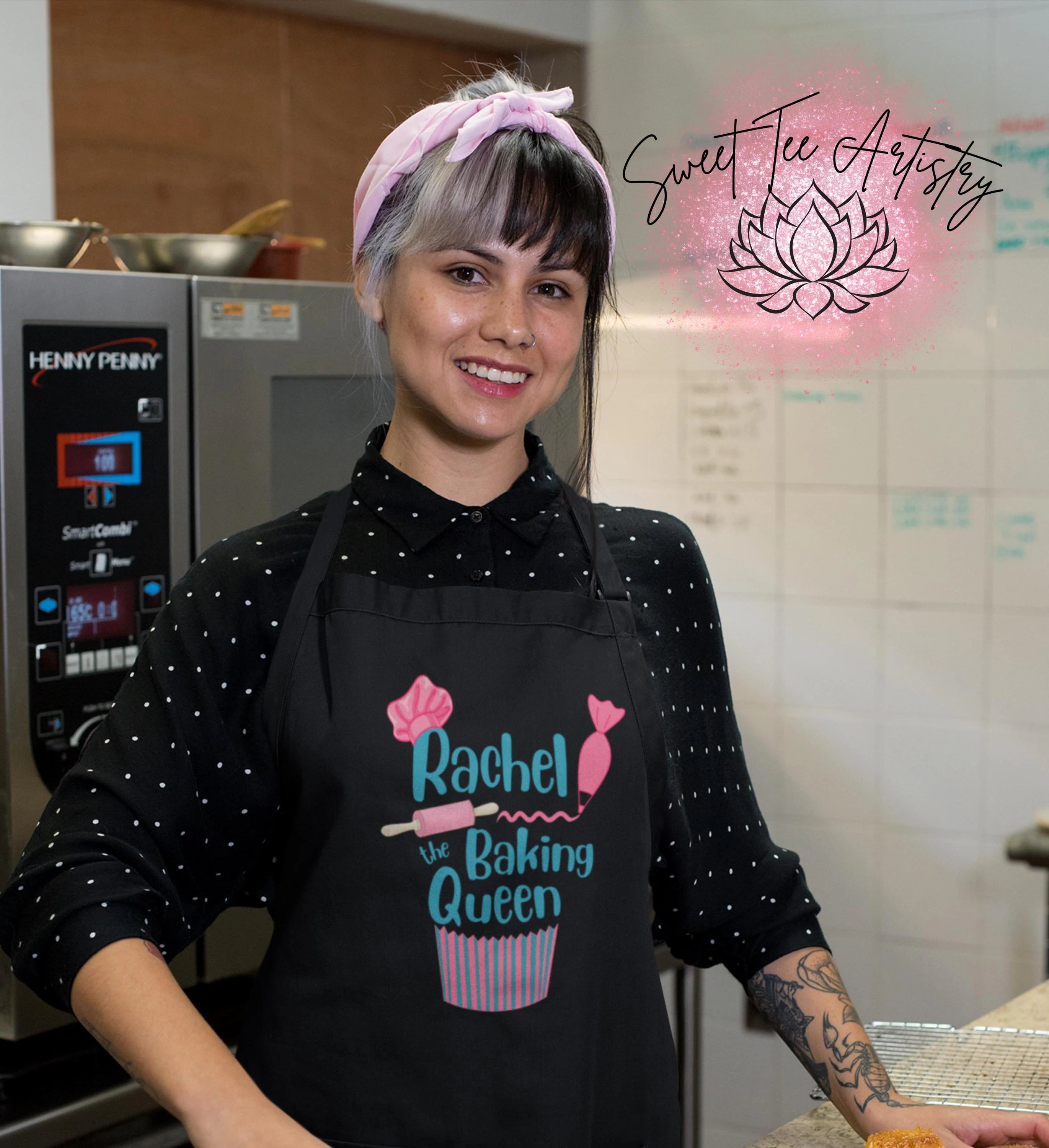 Person wearing a black apron with 'Rachel the Baking Queen' design in a kitchen setting.