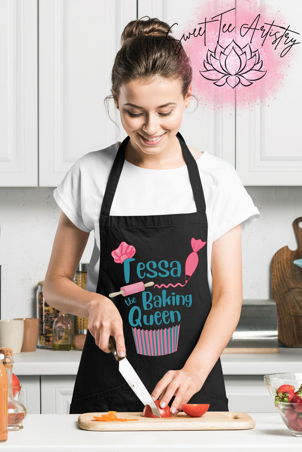 Woman in a kitchen wearing a black apron with 'Tessa the Baking Queen' design, cutting vegetables.
