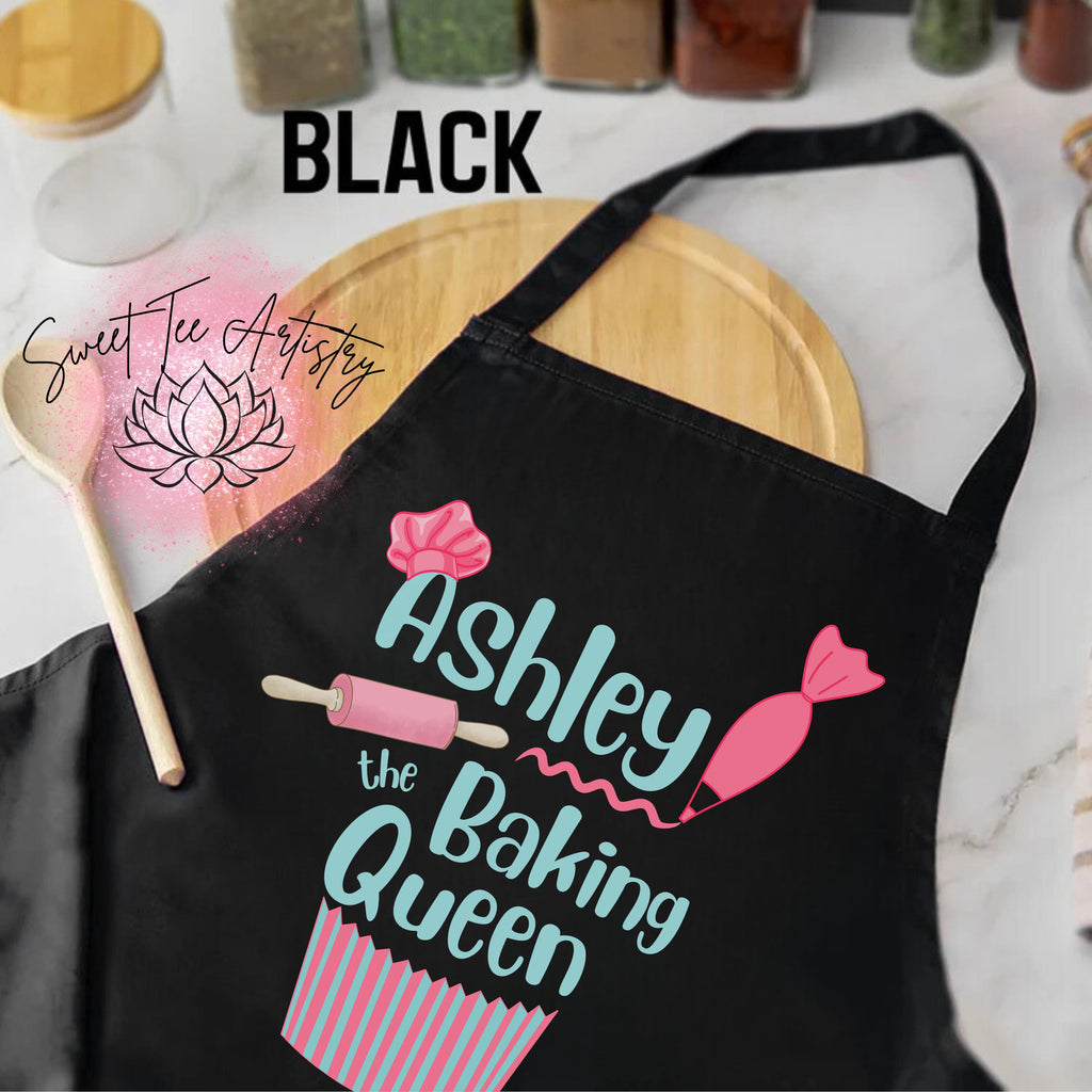Black apron with 'Ashley the Baking Queen' design on a kitchen counter.