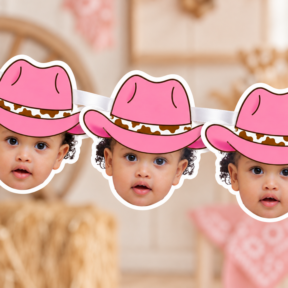 Close up of personalized pink cowgirl hat photo banner panels showing child face cutouts in bright pink cowboy hats threaded together with white satin ribbon