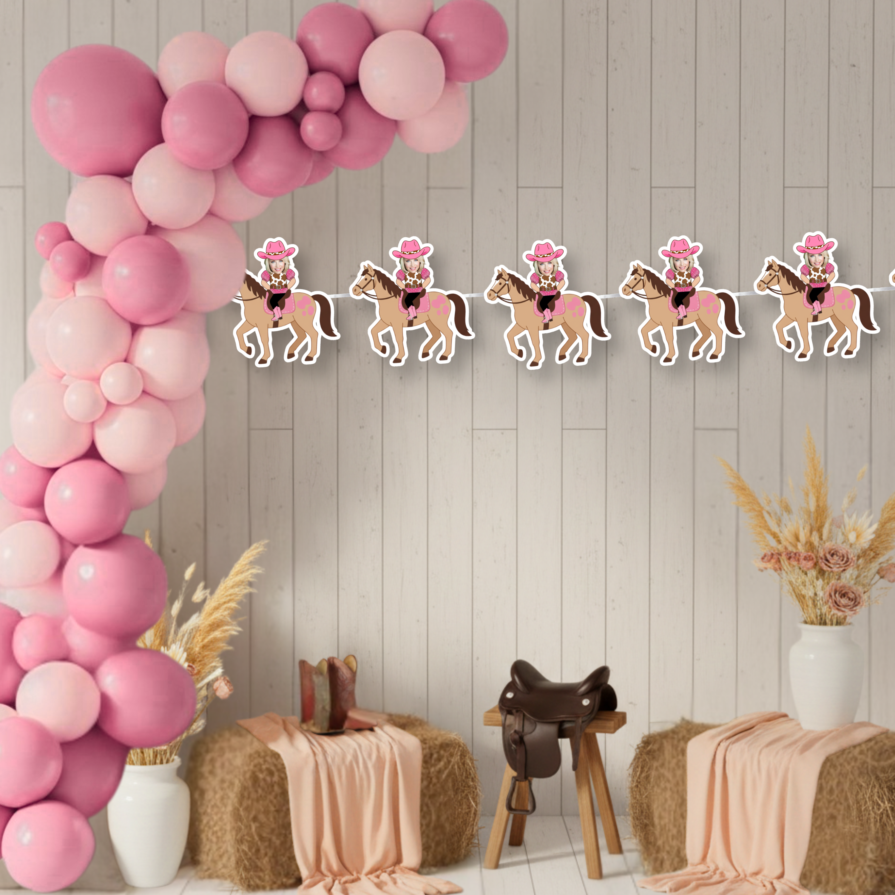Pink western first birthday banner personalized with photo cowgirl panels styled with hay bales, saddle, and rustic decor. A full cowgirl party scene showcasing the personalized My First Rodeo banner for little cowgirl birthdays and western themed celebrations.