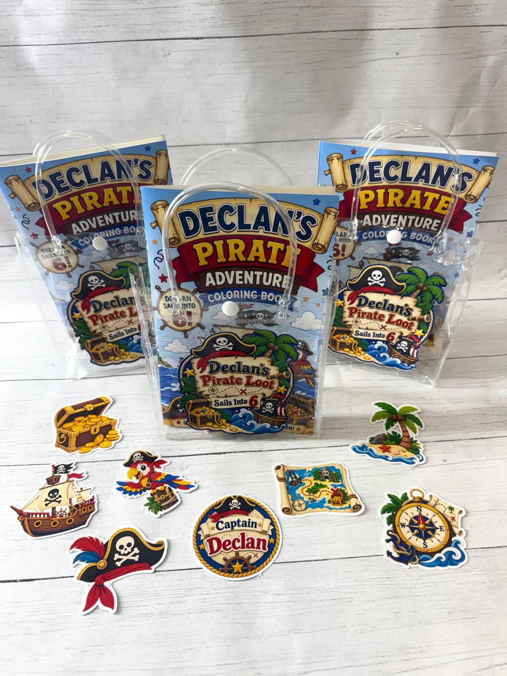 Pirate birthday party favors with personalized coloring books, crayons, sticker packs and matching goodie bags.