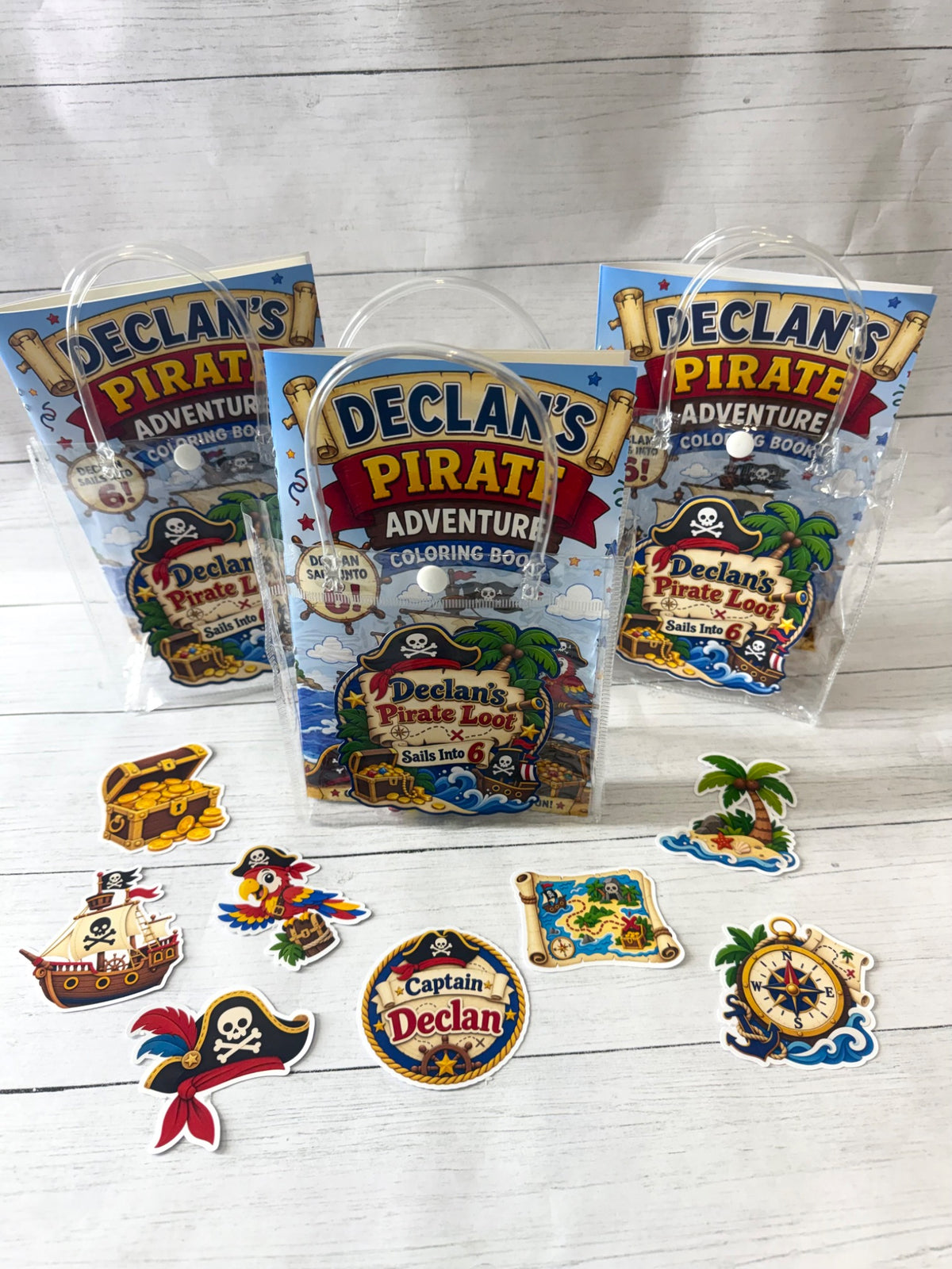 Pirate birthday party favors with personalized coloring books, crayons, sticker packs and matching goodie bags.