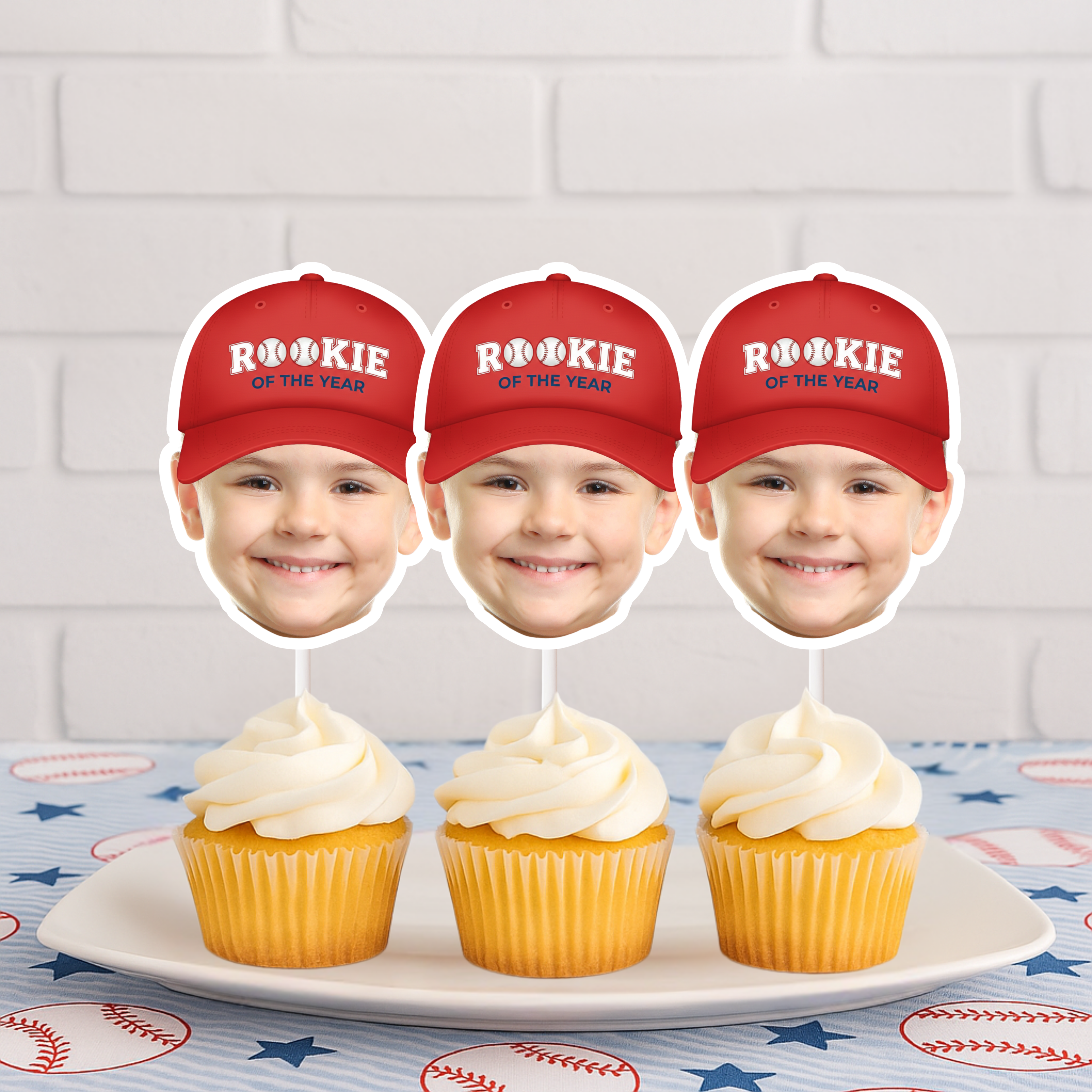 Three personalized Rookie of the Year baseball photo cupcake toppers with red caps displayed on vanilla cupcakes, perfect for a baseball first birthday party, little slugger celebration, and sports themed dessert table decorations.