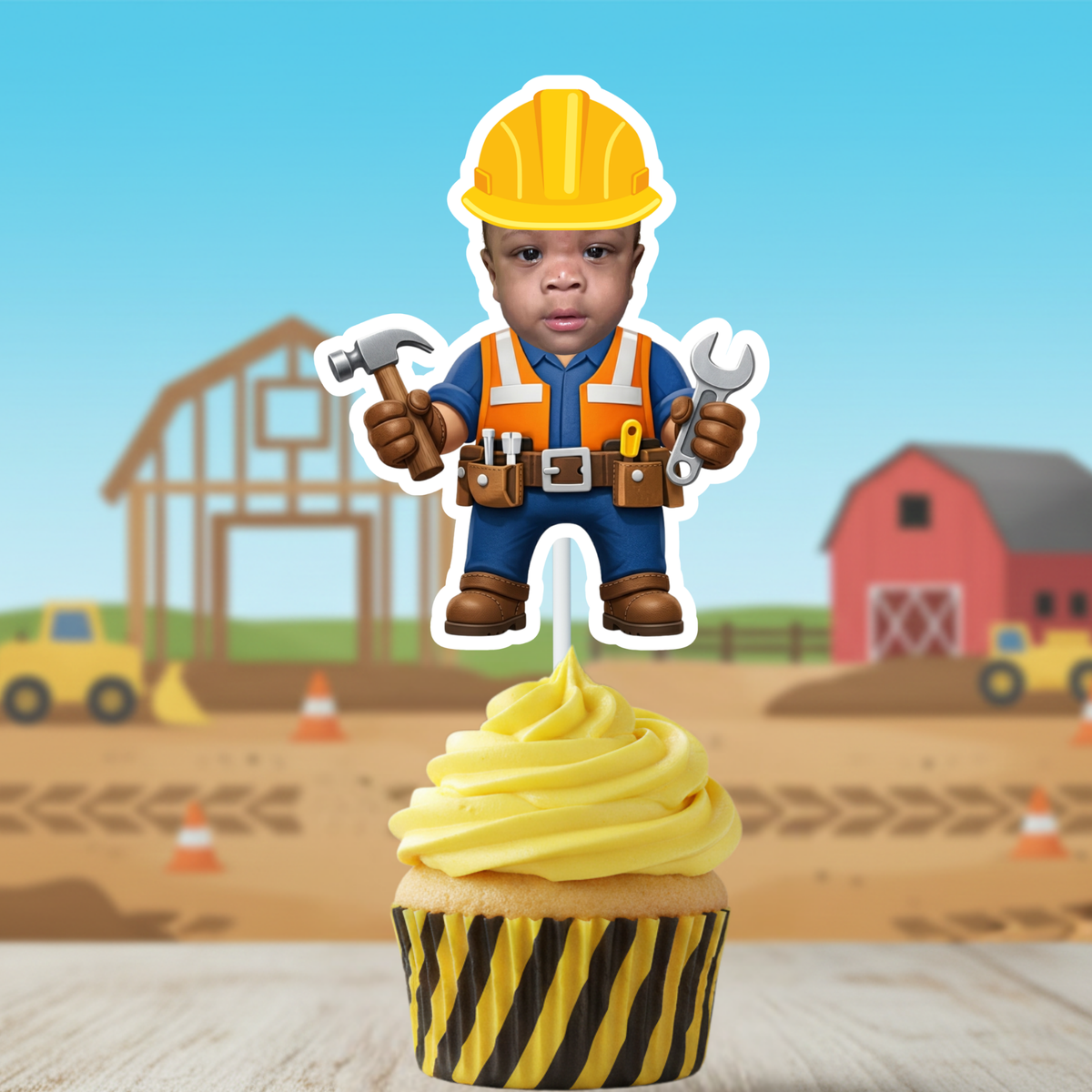 Single personalized construction cupcake topper featuring a childs face in a builder outfit displayed on a cupcake with a construction themed background
